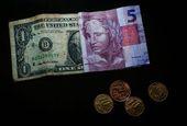 Dólar cai agora mas expectativa é de alta 