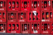 Pilhas de caixas engradados de Coca Cola 